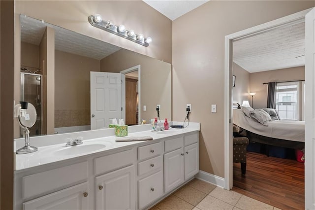 40 Brickton Way E, Dawsonville, GA 30534 - full bath featuring tile patterned flooring, double vanity, ensuite bath, a garden tub, and a stall shower
