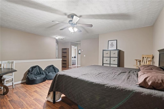 40 Brickton Way E, Dawsonville, GA 30534 - bedroom with wood finished floors, a textured ceiling, and a ceiling fan