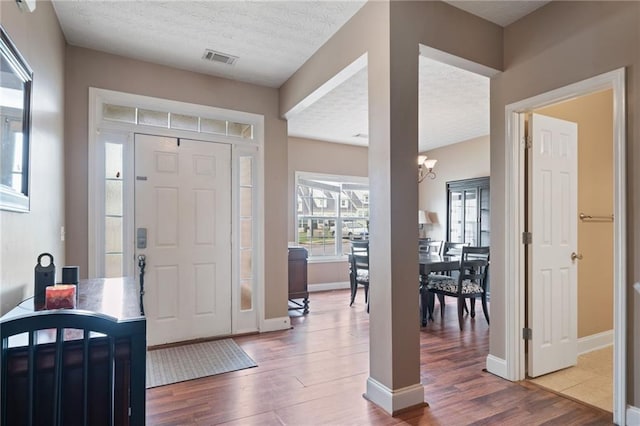 40 Brickton Way E, Dawsonville, GA 30534 - foyer with wood finished floors, a chandelier, and a textured ceiling