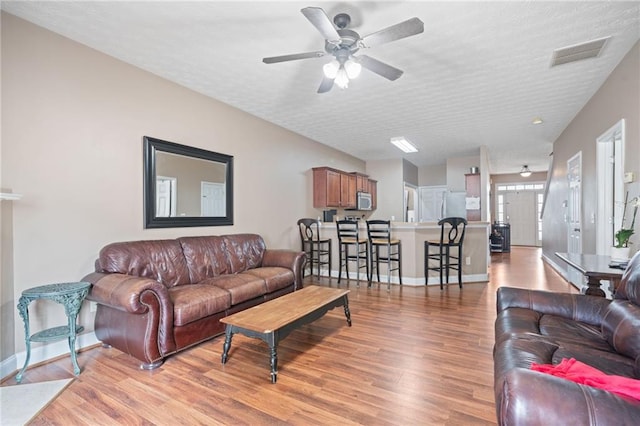40 Brickton Way E, Dawsonville, GA 30534 - living room featuring light wood-type flooring, ceiling fan, and a textured ceiling