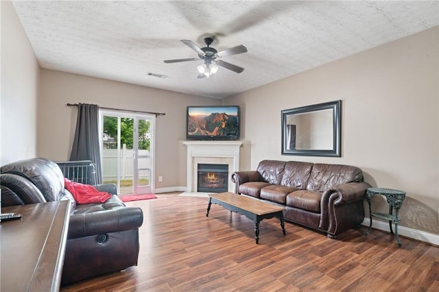 40 Brickton Way E, Dawsonville, GA 30534 - living room with ceiling fan, wood finished floors, and a fireplace with flush hearth