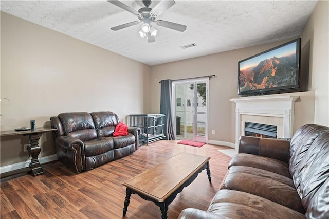 40 Brickton Way E, Dawsonville, GA 30534 - living room with wood finished floors, ceiling fan, and a fireplace