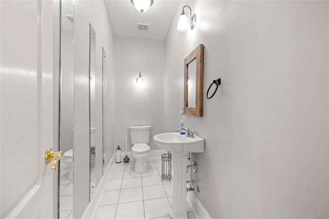 bathroom with tile patterned flooring, a shower, and toilet