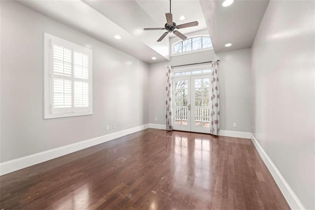 empty room with ceiling fan, vaulted ceiling, recessed lighting, wood finished floors, and french doors