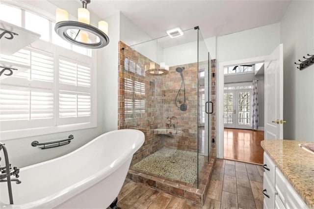 bathroom with french doors, vanity, and independent shower and bath