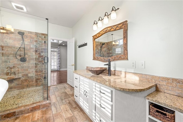 bathroom with vanity, visible vents, a stall shower, and wood finished floors