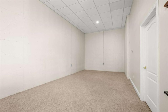 carpeted spare room featuring a paneled ceiling