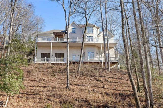 back of house featuring a balcony