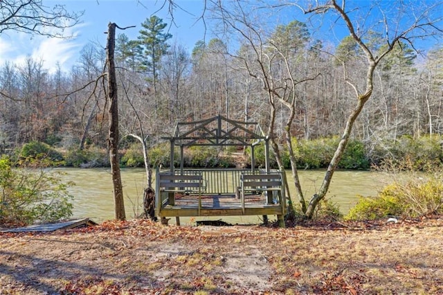 view of dock with a gazebo and a water view