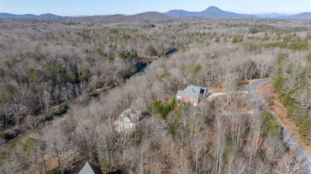 aerial view featuring a forest view and a mountain view