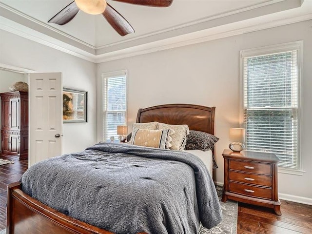 bedroom with multiple windows, ceiling fan, dark hardwood / wood-style flooring, and ornamental molding