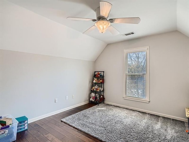 additional living space with dark hardwood / wood-style floors, vaulted ceiling, and ceiling fan