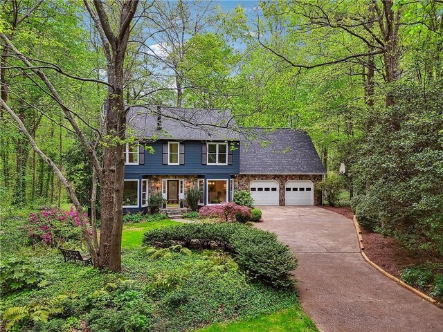 3988 Dover Ave, Alpharetta, GA 30009 - view of front of house with a shingled roof, concrete driveway, a garage, and stone siding