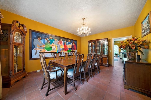 790 Friendship Church Rd, Douglasville, GA 30134 - dining room featuring a chandelier, a textured ceiling, and dark tile patterned flooring