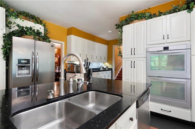 790 Friendship Church Rd, Douglasville, GA 30134 - kitchen with appliances with stainless steel finishes, white cabinetry, and dark stone counters