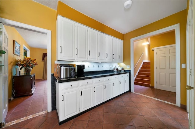 790 Friendship Church Rd, Douglasville, GA 30134 - kitchen featuring dark tile patterned flooring, dark countertops, and white cabinetry