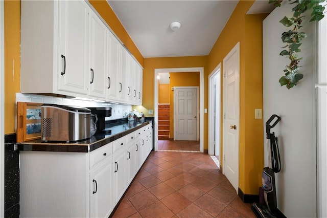 790 Friendship Church Rd, Douglasville, GA 30134 - kitchen with dark countertops, white cabinetry, and tile patterned floors