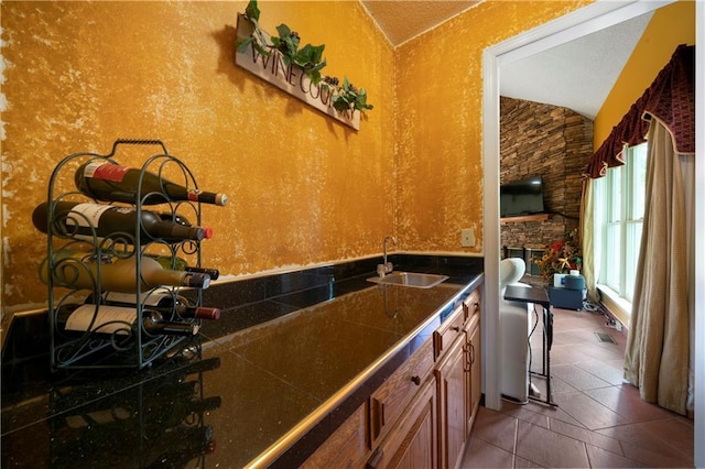 790 Friendship Church Rd, Douglasville, GA 30134 - kitchen featuring vaulted ceiling, brown cabinetry, and tile countertops