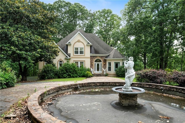 790 Friendship Church Rd, Douglasville, GA 30134 - traditional home featuring stucco siding, roof with shingles, and curved driveway