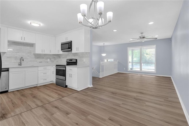 2496 Shiloh Dr, Decatur, GA 30034 - kitchen featuring stainless steel appliances, light countertops, backsplash, a sink, and recessed lighting
