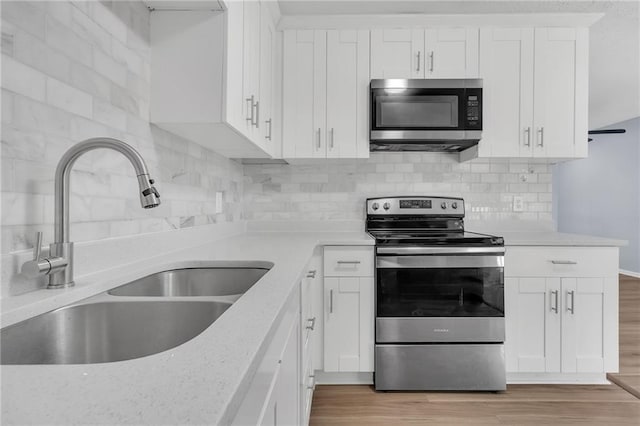 2496 Shiloh Dr, Decatur, GA 30034 - kitchen with appliances with stainless steel finishes, a sink, backsplash, and light stone countertops