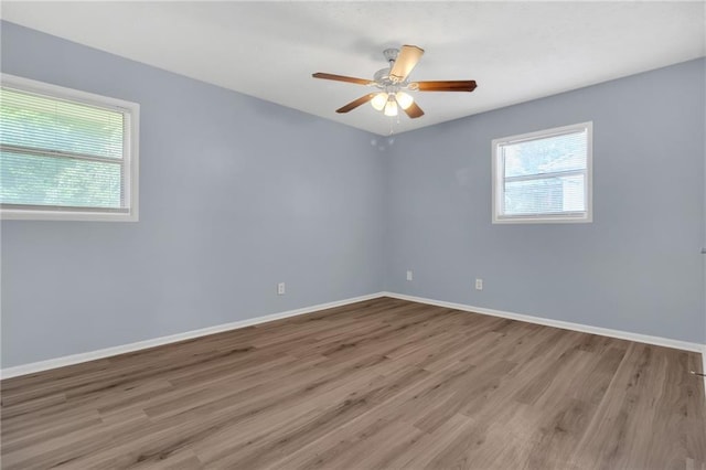 2496 Shiloh Dr, Decatur, GA 30034 - empty room with healthy amount of natural light, wood finished floors, a ceiling fan, and baseboards