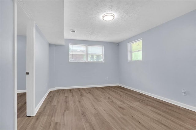 2496 Shiloh Dr, Decatur, GA 30034 - spare room with a textured ceiling, light wood-type flooring, and baseboards