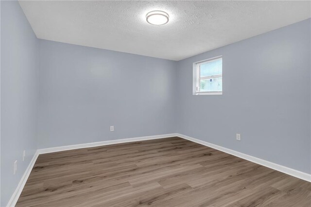 2496 Shiloh Dr, Decatur, GA 30034 - unfurnished room featuring wood finished floors, a textured ceiling, and baseboards
