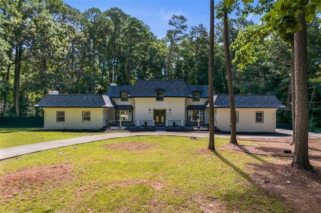 french country style house featuring a front yard