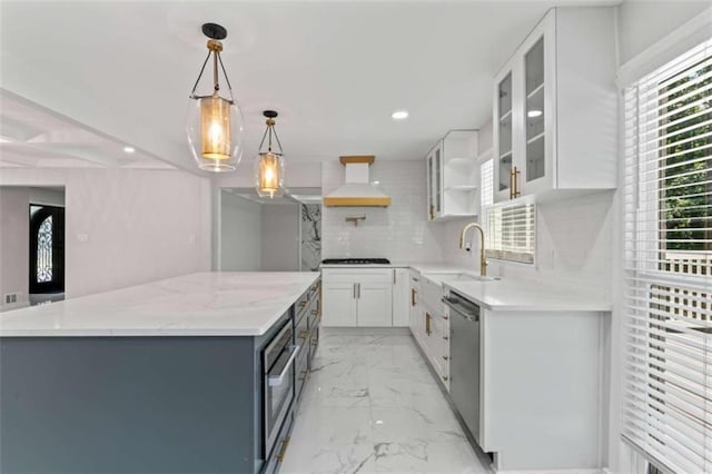 kitchen with a sink, decorative backsplash, custom range hood, stainless steel dishwasher, and marble finish floor