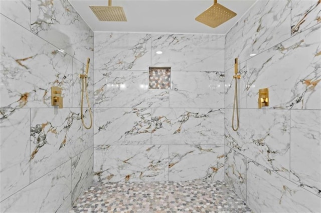 bathroom with visible vents and a marble finish shower