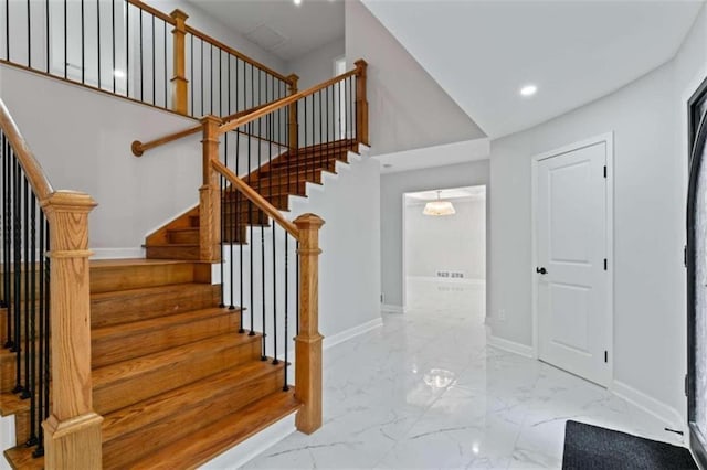 staircase featuring recessed lighting, baseboards, and marble finish floor