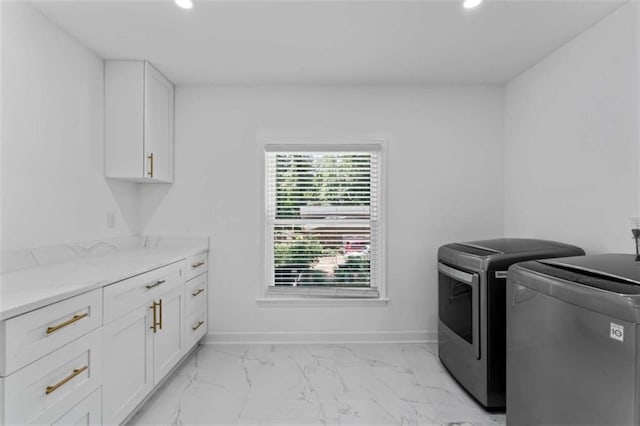 laundry area featuring marble finish floor, recessed lighting, cabinet space, baseboards, and washing machine and clothes dryer