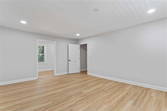 unfurnished room featuring recessed lighting, baseboards, and light wood-type flooring