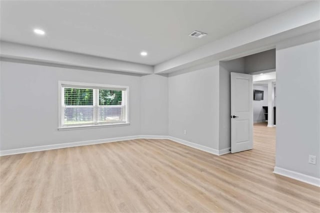 empty room with visible vents, recessed lighting, light wood-type flooring, and baseboards