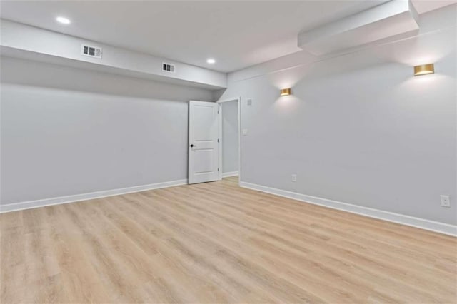 unfurnished room with visible vents, baseboards, and light wood-style floors