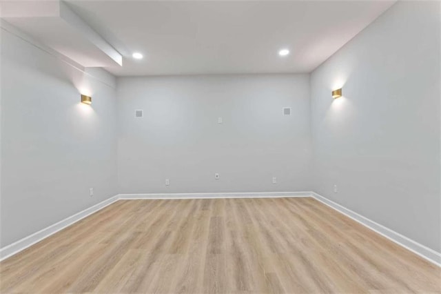 spare room with recessed lighting, baseboards, and light wood-style flooring