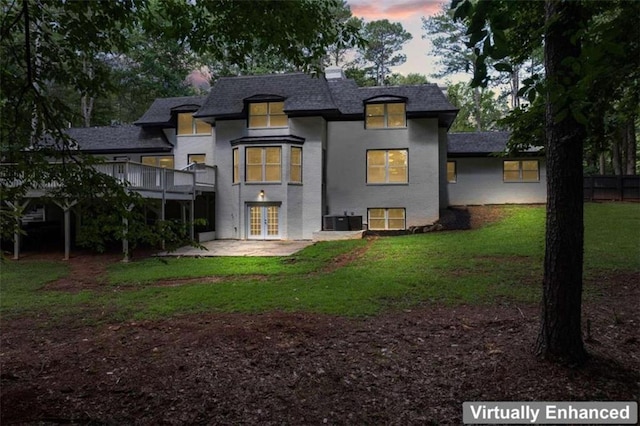 rear view of property with a wooden deck, cooling unit, french doors, a yard, and a patio area