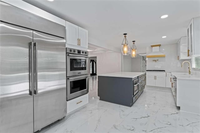 kitchen featuring premium range hood, stainless steel appliances, white cabinets, and light countertops