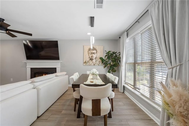 4901 Wilkie Way NW, Acworth, GA 30102 - dining room with ceiling fan, a lit fireplace, and light wood-type flooring
