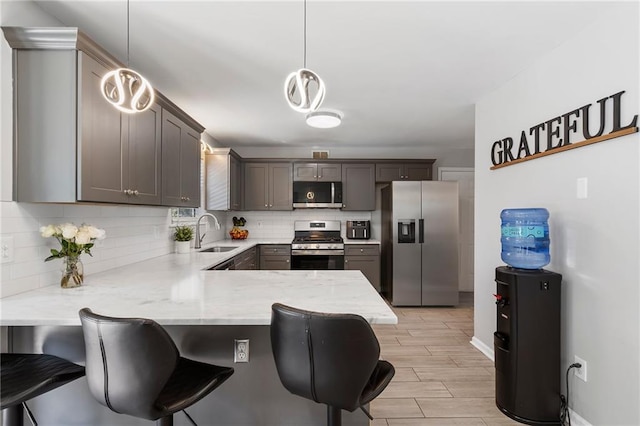 4901 Wilkie Way NW, Acworth, GA 30102 - kitchen featuring stainless steel appliances, a peninsula, tasteful backsplash, and a kitchen bar