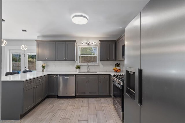 4901 Wilkie Way NW, Acworth, GA 30102 - kitchen featuring appliances with stainless steel finishes, a peninsula, gray cabinets, and decorative backsplash