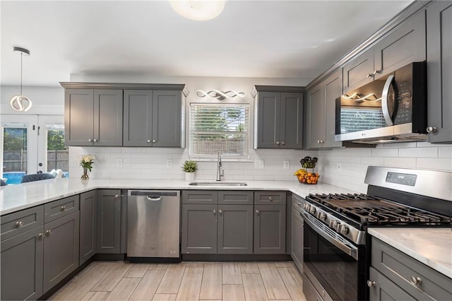 4901 Wilkie Way NW, Acworth, GA 30102 - kitchen featuring stainless steel appliances, tasteful backsplash, gray cabinets, and light wood finished floors