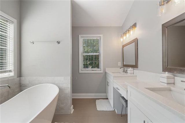 4901 Wilkie Way NW, Acworth, GA 30102 - bathroom featuring a freestanding bath, double vanity, tile patterned floors, and tile walls