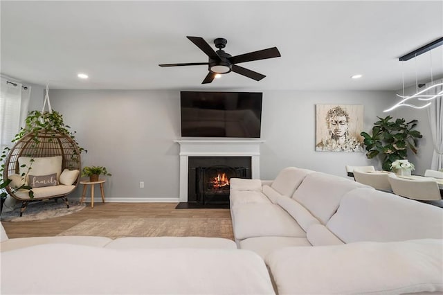 4901 Wilkie Way NW, Acworth, GA 30102 - living room featuring wood finished floors, recessed lighting, a warm lit fireplace, and a ceiling fan