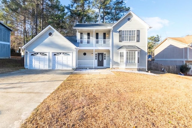 view of property featuring a garage and a balcony