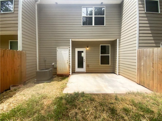 doorway to property featuring central AC unit and a patio