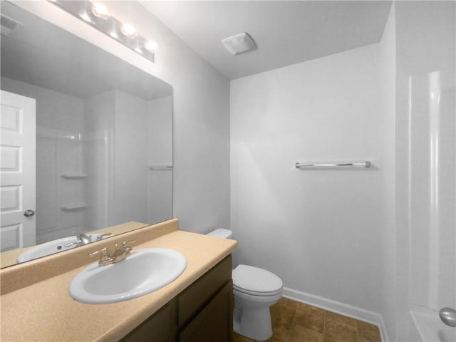 bathroom with vanity, toilet, and a shower