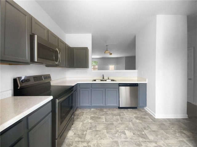 kitchen with gray cabinets, appliances with stainless steel finishes, and sink