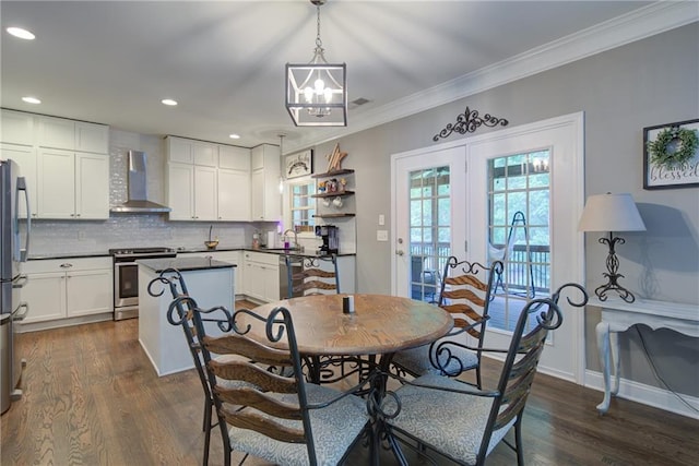 dining space with a chandelier, ornamental molding, dark wood-type flooring, recessed lighting, and baseboards